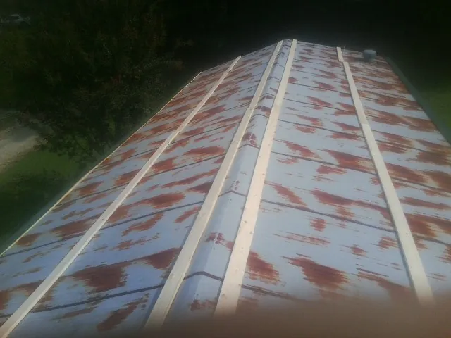 Rusted metal roof panels with new wood purlins before replacement — Storm Damage Roof Repair in Gainesville by Roofing Brothers